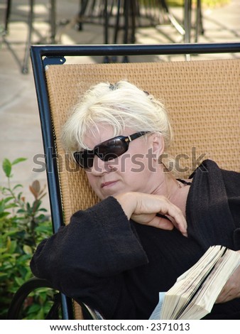 blonde woman reading a book
