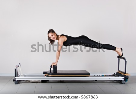Reformer front support position. Pilates gymnastics is a Germanic evolution of yoga, used by athletes to improve flexibility and body fitness and by chiropractors for patient recovery.