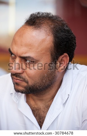 portrait of a mid age egyptian man listening with attention