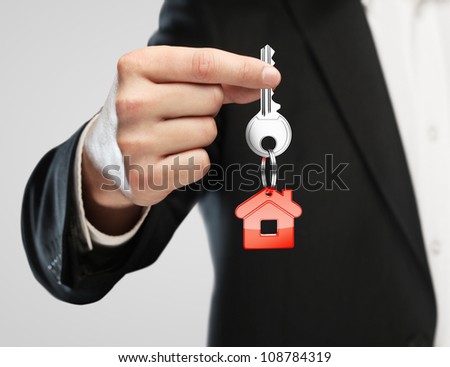 red key chain with key in hand  businessman