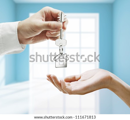 passing key against backdrop of blue room