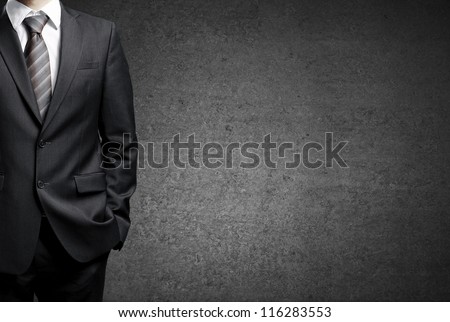man in suit on a concrete wall background