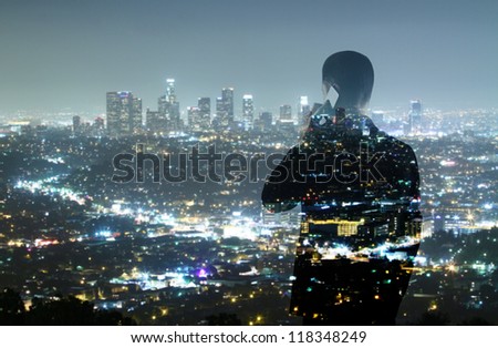businessman with phone looking in night city