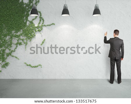 businessman drawing on wall and ivy