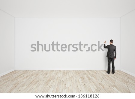 man drawing on white wall
