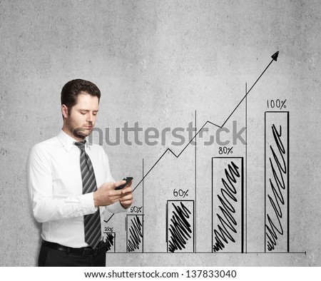 businessman holding phone and drawing graph on wall