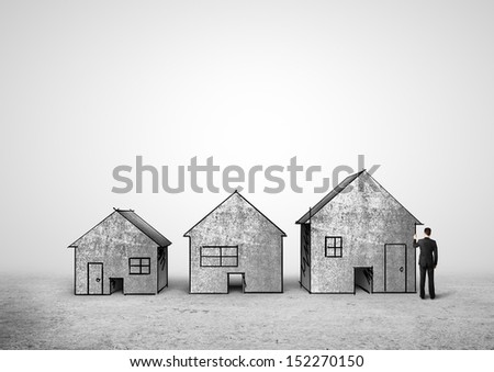 businessman in suit drawing concrete houses