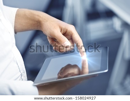 hand holding and pushing tablet, close up