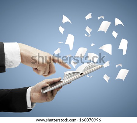 hands holding touch pad with open book
