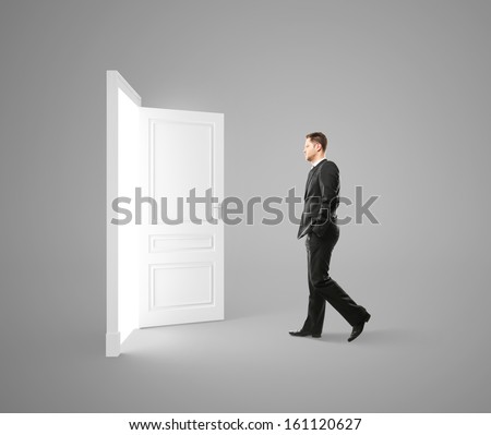 young man walking to opened door