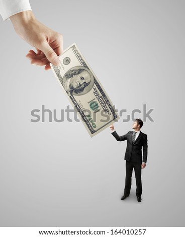 big hand giving money to businessman