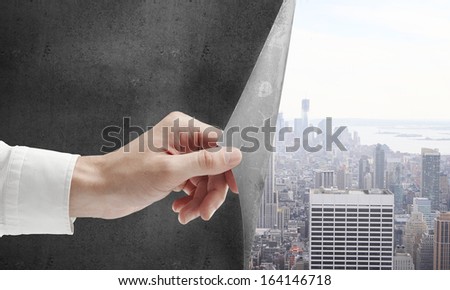 hand turns concrete page to city