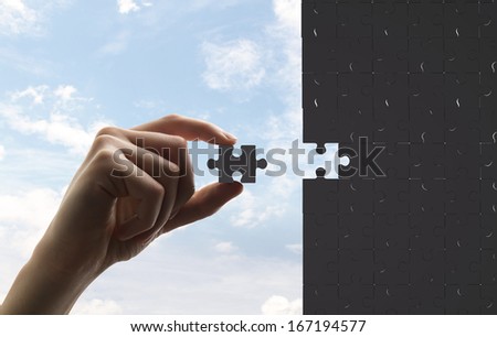 businessman built of puzzle on sky background