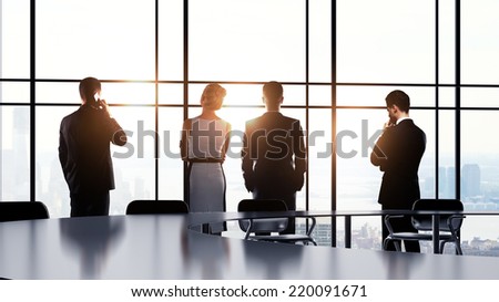 business people in office and looking to window