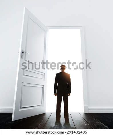 young man in white room with doors open