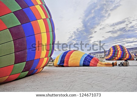 Hot air ballons laid flat on the surface, making ready for the next flights. Location of generic shot is Cappadocia Turkey