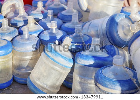 Empty drinking water bottles for dispensers gathering dust in the open on the Quayside at Bet Dwarka in Gujarat India present a public health risk which would not be allowed by authorities in the west