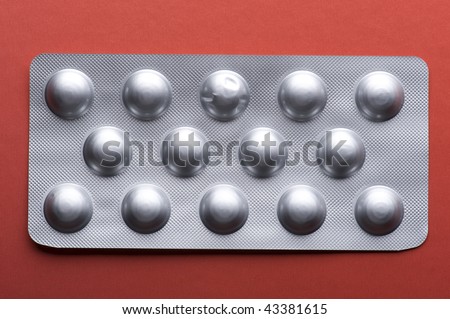 object on red - medical Tablet close up
