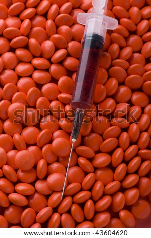 object on red - Medical Tablets and syringe close up