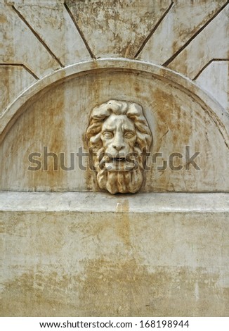 Fountain with a lion\'s head on the wall