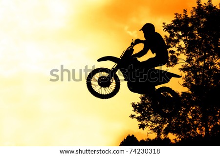 MX Rider silhouette on fire sky