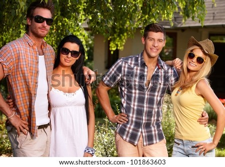 Young couples smiling in the garden at summertime.