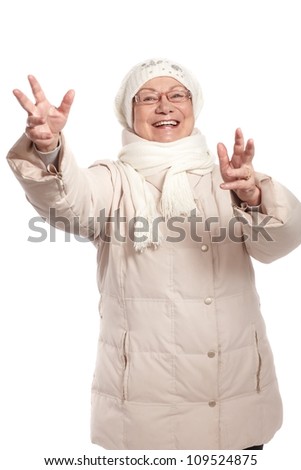 Happy old lady smiling with open arms at wintertime.