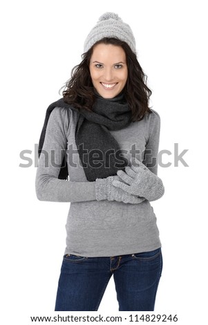 Portrait of happy attractive woman in winter clothes, scarf, cap and gloves, isolated on white.