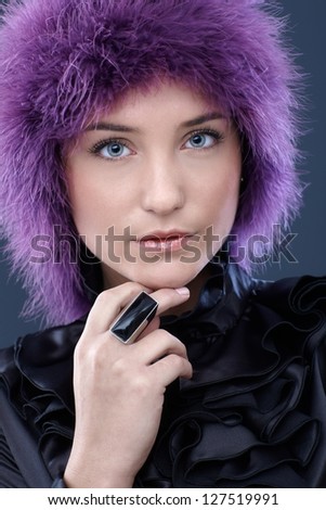 Portrait of beautiful woman in purple wig, posing, smart shirt and black ring.