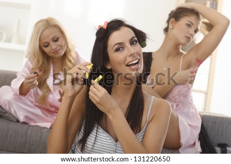 Roommates having beauty treatment at home, preparing themselves to night party.