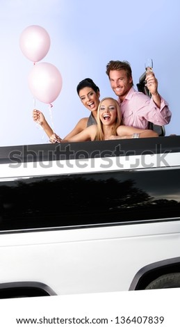 Attractive young people having party fun in limousine.