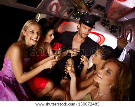 Hot bachelorette party party in limousine with handsome chauffeur and beautiful girls.