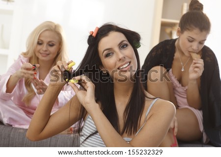 Attractive female roommates preparing for the night party, beauty treatment.