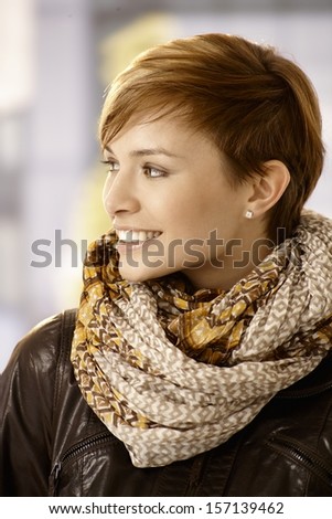 Profile portrait of Young woman wearing scarf and leather jacket