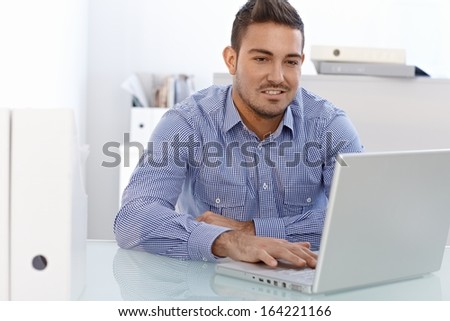 Young businessman working on laptop computer.