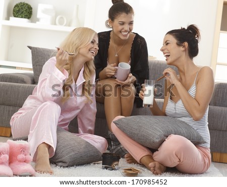 Roommates spending an evening together in pyjamas, chatting, having fun.