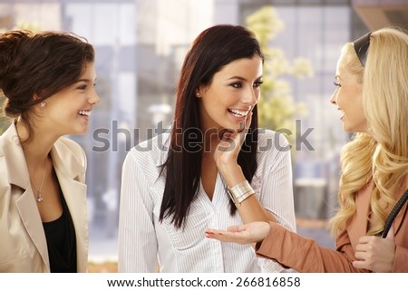 Pretty female friends chatting, smiling happy outdoors.