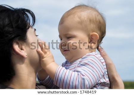 A very intimate moment: a one year old baby fondles his mother.