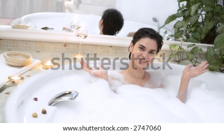 Young woman enjoys the bath in a whirlpool tube.