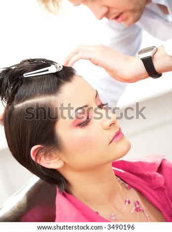 Beautiful young woman gets a hairdo in the beauty-shop.