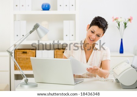 Business woman working on laptop computer at home.