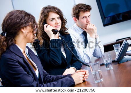 Young business people having meeting at office, businesswoman calling on phone.