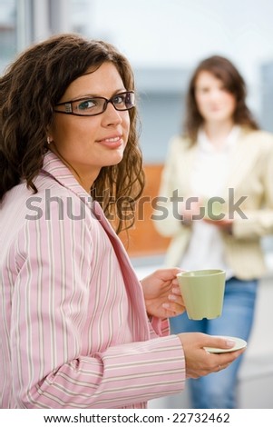 Young happy office workers having break at office drinking coffee.