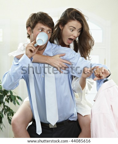 Panicked couple packing in the morning at home, they are late for work.