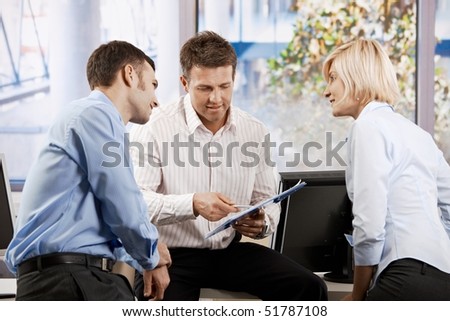 Business team working in office, people talking smiling.