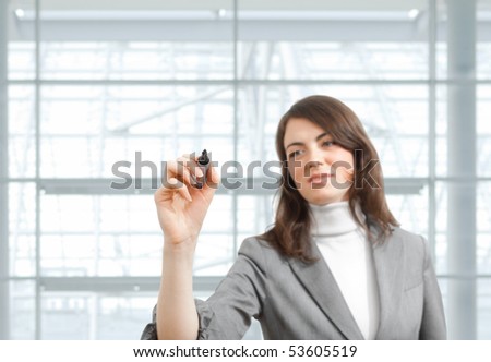 Young businesswoman drawing with marker pen, selective focus on hand.