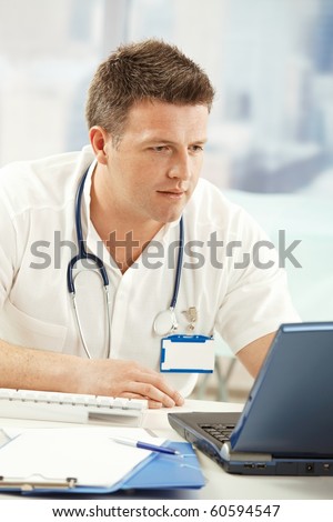Portrait of medical professional working on computer in doctor\'s office.?