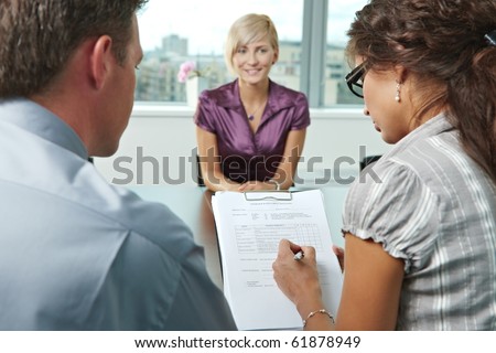 Conductors holding questionnaire form during the job interview, applicant\'s reults are excellent. Focus placed on sheet in front.