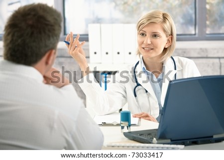 Confident female doctor discussing diagnosis with patient in office, smiling.?