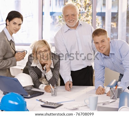 Portrait of happy designer team working together, smiling at camera in office.?